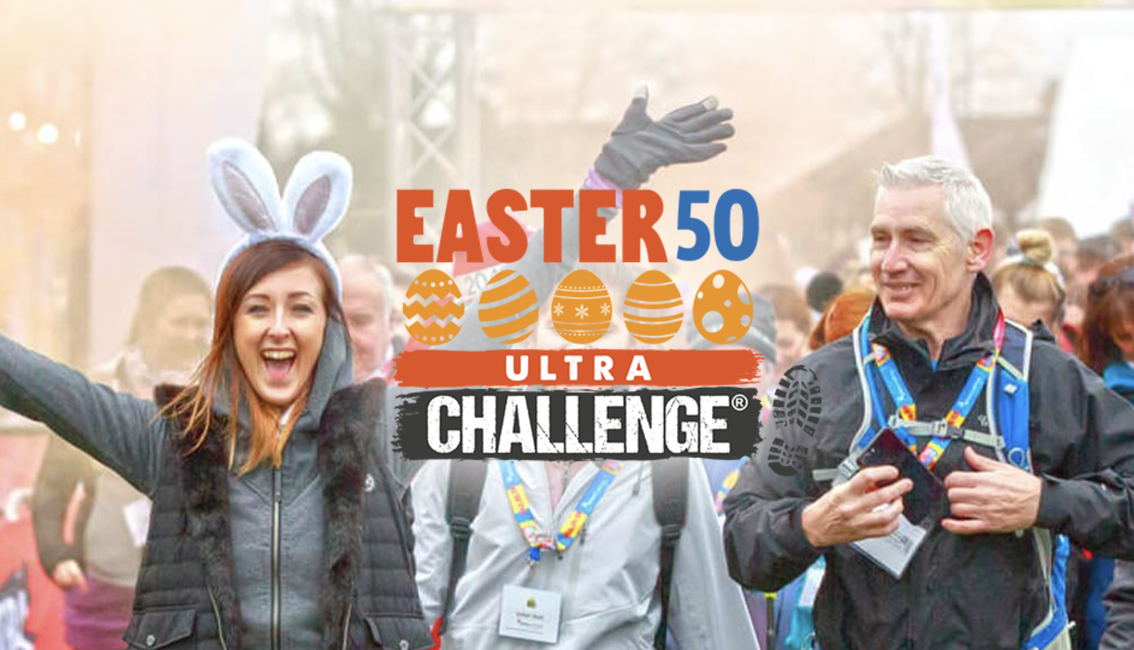 A promotional graphic for the "Easter 50 Ultra Challenge," featuring the event name in bold text accompanied by a row of colorful Easter egg icons. The background shows a lively scene of participants smiling and walking, including a woman wearing bunny ears and raising her arms in celebration, alongside a man with a medal and lanyard. The atmosphere is festive and energetic, emphasising the fun and achievement of the challenge. Boot print graphics at the bottom of the logo highlight the event's active nature.