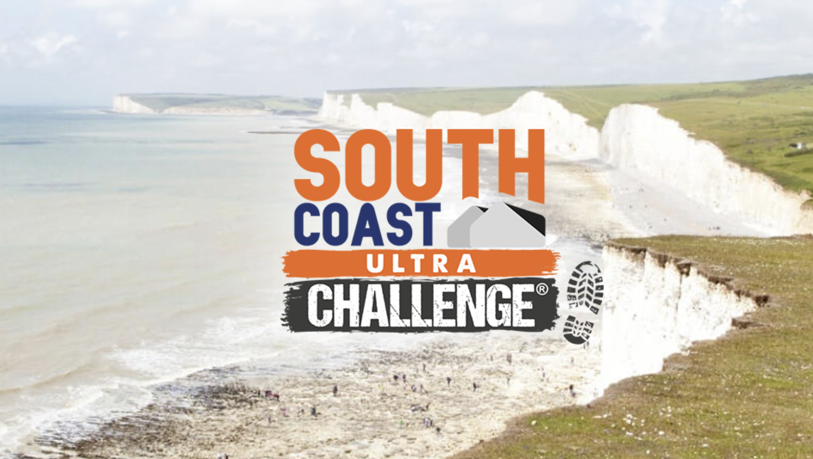 Spectacular view of the South Coast's iconic white chalk cliffs overlooking the sea, with grassy hilltops and a pebble beach below. The South Coast Ultra Challenge logo is prominently displayed over the image, highlighting the scenic coastal setting.